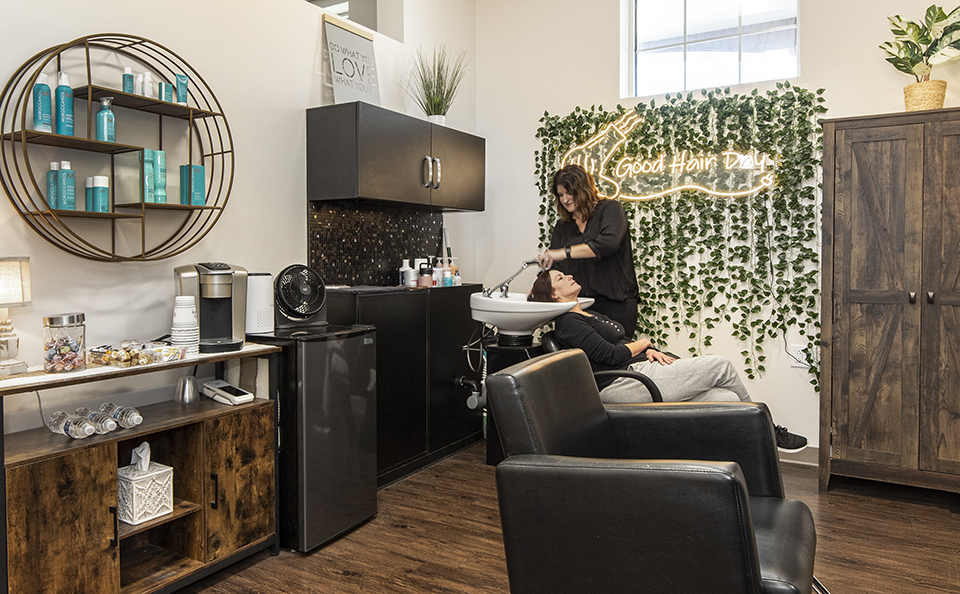 stylist shampooing hair in her suite at Gallery of Hair Colorists